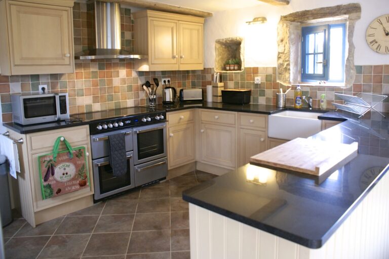 The kitchen, with a range cooker, butler sink and granite worktops