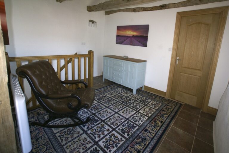 The first-floor sitting area, with stairs down to the hall