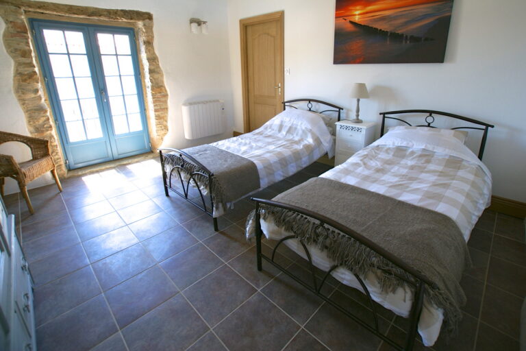 Bedroom 3, a twin room with doors onto a false balcony