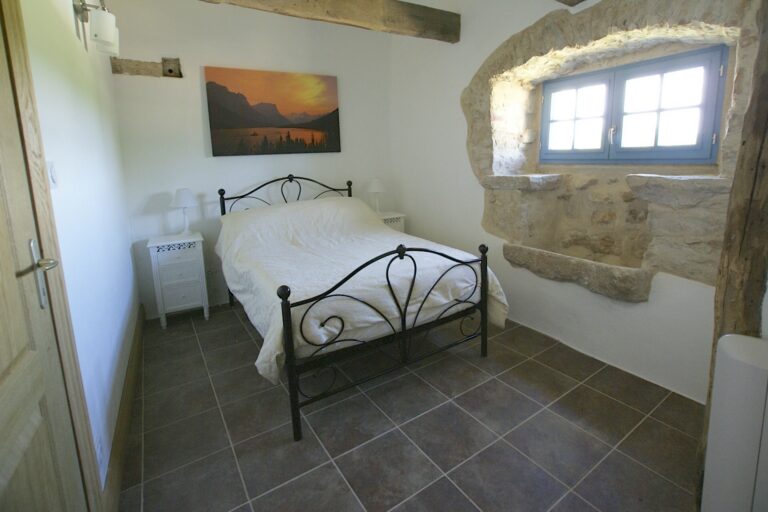 Bedroom 2, a double with an old stone evier and a view over the pool
