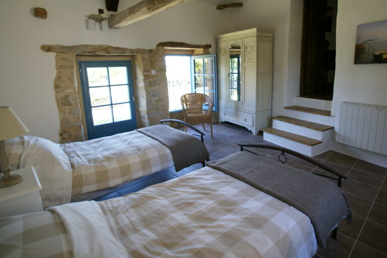 Bedroom 5, a twin room under A-frame timbers, down a few steps from the landing