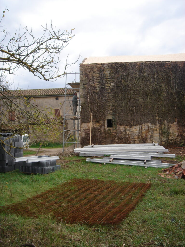 Scaffolding up and building materials waiting on the grass during the restoration